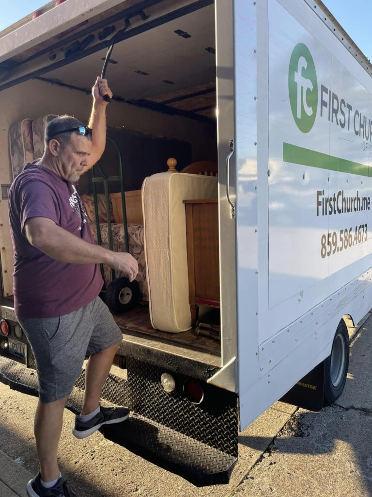 Jerry closing the door to a large moving truck